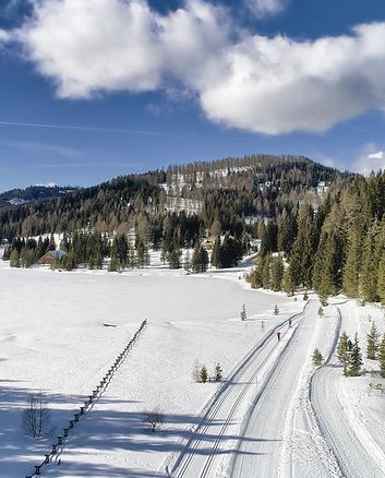 Snowy landscape in Lungau region with pine trees and mountains.