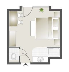 Grundriss eines Einzelzimmers mit Doppelbett, Bad und Schreibtisch.